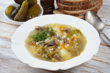 Soup with beef meat, pickled cucumbers and pearl barley.  Rassolnik- traditional Russian cuisine cucumber soup