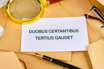 DUOBUS CERTANTIBUS TERTIUS GAUDET it means in Latin While two argue, the third rejoices. on a blank...