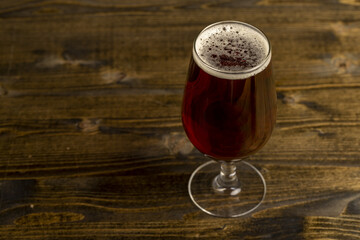 dark beer in a glass glass, fresh dark alcoholic beer