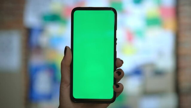 Woman and person using cell phones with green screens, modern tech