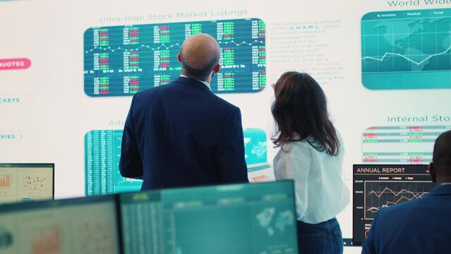 Forecast affiliates deciding new direction to improve business efficiency, reviewing latest enterprise news and progress. Worker and general director working to expand the company. Camera A.