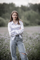 Portrait of a young beautiful long-haired girl outdoors.