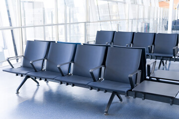 Departure lounge at the airport with seats in a row