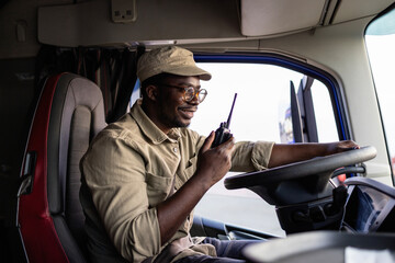 Professional truck driver talking with dispatcher on the radio.