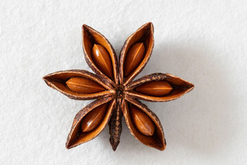 Macrophotography of dried star anise seeds against a white background