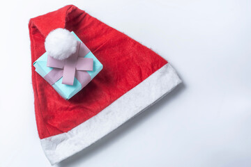 Christmas concept. Santa Claus hat and gift box on white background.