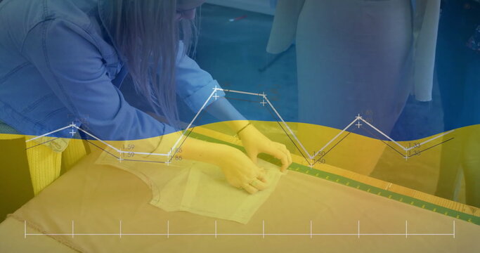 Image of graph and waving flag of ukraine over caucasian coworkers discussing in office - Powered by Adobe