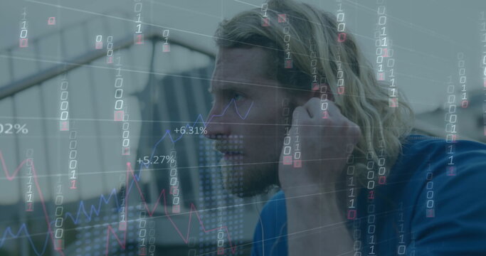 Image of falling binary codes, graphs, changing numbers, caucasian man adjusting headphones - Powered by Adobe
