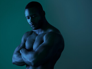 Confident, bodybuilder and man shirtless in studio strong arms, power and muscular body for...