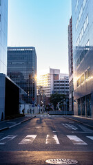 A city with the sun setting through the buildings