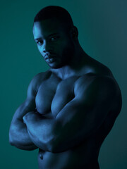 Confident, portrait and black man shirtless in studio strong , power and muscular body for sports training. Bodybuilder, fitness and exercise with strength workout for health on green background