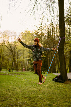 Young man balancing on slackline.