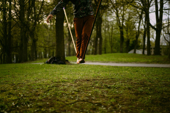 Young man balancing on slackline.