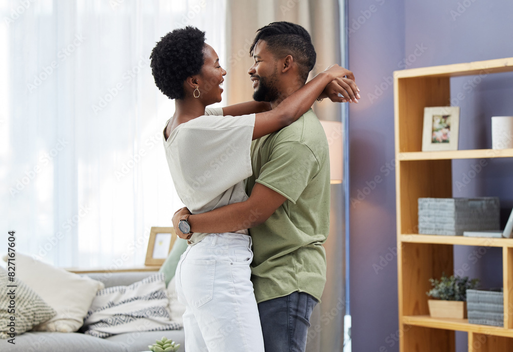 Poster Black couple, dancing and hug in living room happy and in love for relationship, romance or commitment. Smiling, man and woman embrace in home together for relaxing, dating fun and bonding on weekend