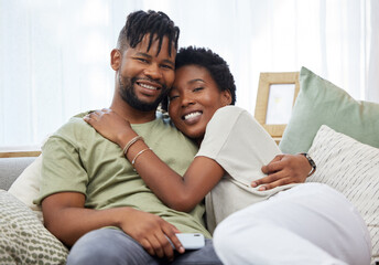 Portrait, couple and love with smile in home for commitment, marriage and happy together on sofa. Man, African woman and hug in apartment for morning, partner and romance in living room for relax
