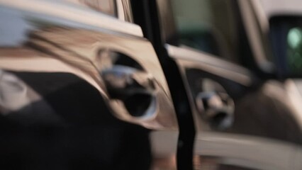 exclusive driver opens the electric door of the black van
