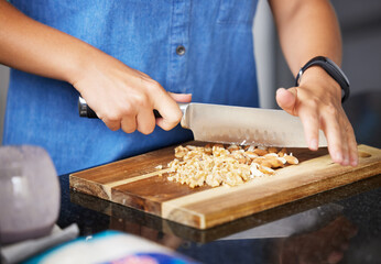 Chopping board, hands and almond nuts for healthy food, snack and meal prep in kitchen with recipe....