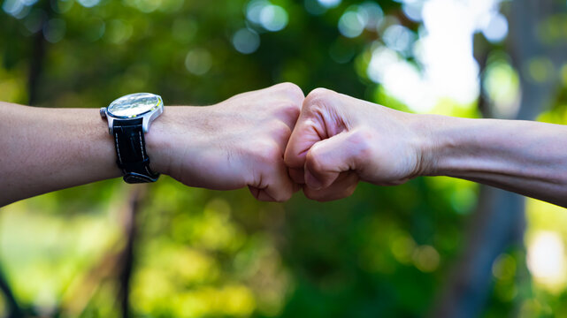 Deal of teamwork with the Man hand a fist bump commit as get together in the office.