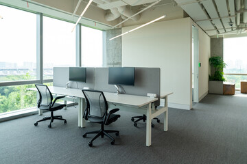 Interior of modern empty office building.Open ceiling design.Equipped with automatic lifting table and LCD screen.