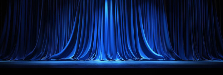 Elegant blue stage curtain with dramatic lighting creating a luxurious and sophisticated ambiance in a theatrical setting
