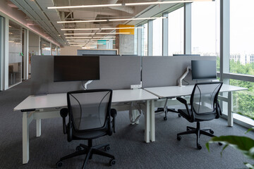 Interior of modern empty office building.Open ceiling design.Equipped with automatic lifting table and LCD screen.