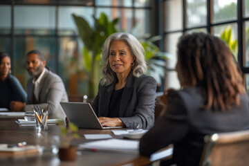 Fototapeta premium Seasoned businesswoman leads a conference with confidence, displaying leadership presence in a corporate boardroom setting