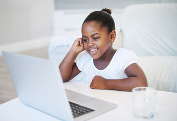 Laptop, elearning and black child by desk in home for development, homework and knowledge. Technology, smile and girl student in virtual class with computer for online distance education at house.