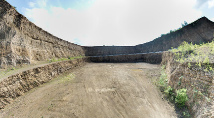 Obraz premium Open-pit mining sounds like a giant sandbox for adults, doesn't it? Imagine huge machines that look like oversized toy excavators