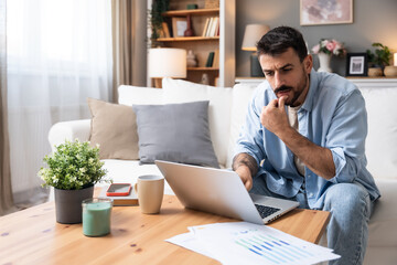 Career winner mindset. Young freelance businessman working at home. Confident dedicated male learning and educate himself for better opportunity in her business career, work on laptop computer.