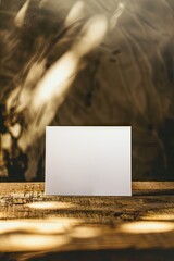 a mockup of a blank white postcard standing on a wooden table
