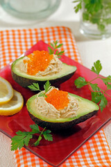 Stuffed avocados with crab cream and caviar.