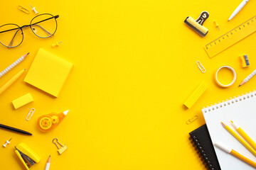 Vibrant Office Supplies. A colorful flat lay of essential stationery items on a yellow background,...