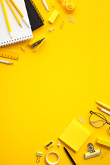Flat lay modern workspace with office supplies on yellow background. Banner design for themes...