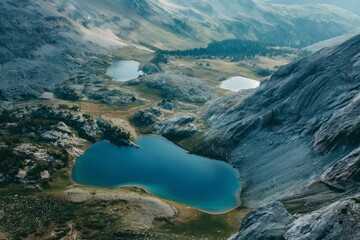Tranquil aerial view of alpine lakes nestled among rugged mountains during twilight hours