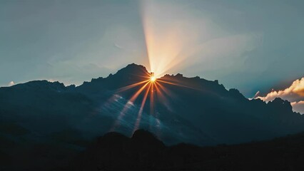 A mountain peak is enveloped in a soft glow as the crepuscular rays from the setting sun peek through the rocky terrain and create a breathtaking view. - Powered by Adobe