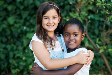 Children, diversity and hug with girl friends outdoor in garden together for summer bonding. Love,...