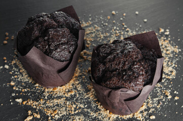 Chocolate muffins close up on a black background