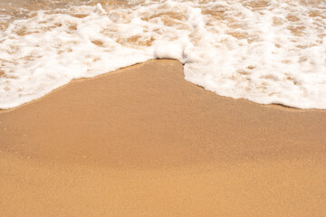 Sea wave and sand on the beach with copy space for text. 