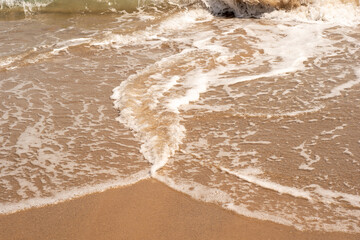 Sea wave and sand on the beach with copy space for text. 
