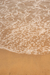 Sea wave and sand on the beach with copy space for text. 