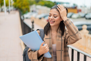 Young pretty student woman at outdoors has realized something and intending the solution