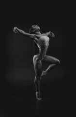 Black and white image of a sports woman in the studio. Beautiful body.