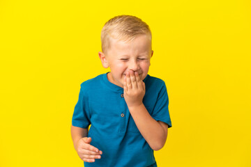 Little Russian boy isolated on yellow background happy and smiling covering mouth with hand
