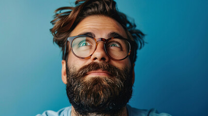Attractive male with a beard and fashionable eyewear, looking happy and confident