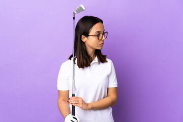 Young golfer woman over isolated colorful background keeping the arms crossed