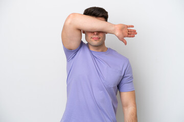 Young caucasian man isolated on white background covering eyes by hands