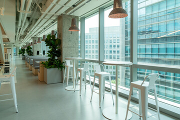Interior of modern empty office lobby.Open ceiling design.There are floor-to-ceiling Windows and...