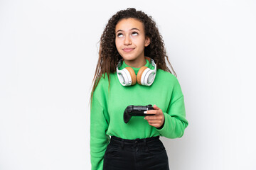 Young Arab woman playing with a video game controller isolated on white background and looking up