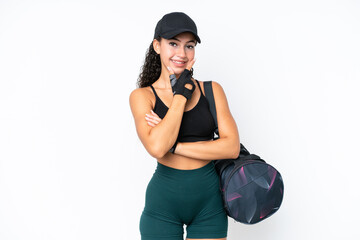Young sport woman with sport bag isolated on white background smiling