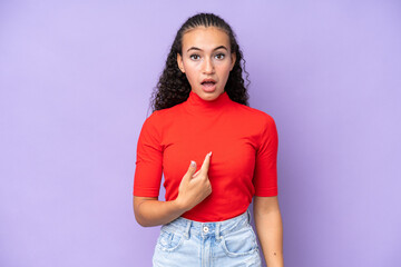 Young woman isolated on purple background pointing to oneself